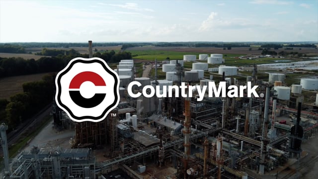 Country Mark Logo overlaying refinery landscape photo